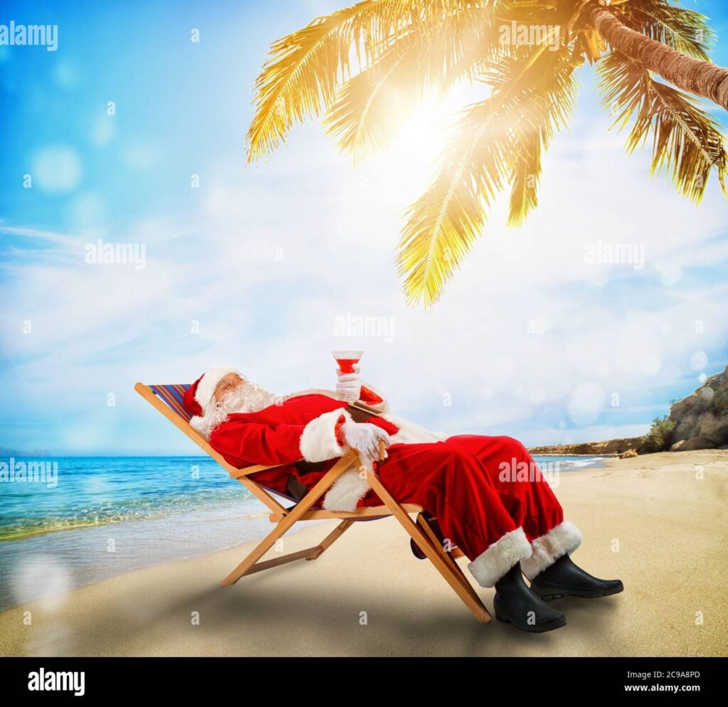 Santa Claus Relaxing On A Deckchair In A Tropical Beach Stock Photo Alamy